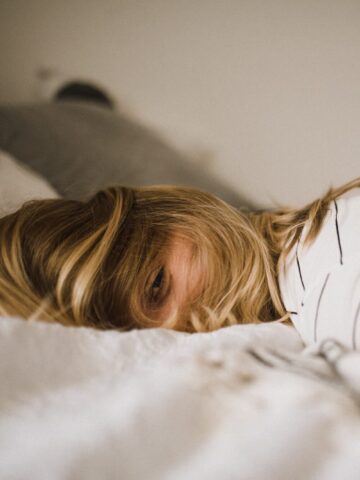female napping on bed | lifestyle | Photo by Kinga Cichewicz on Unsplash | hearth health happiness
